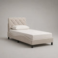 Lit simple 90 x 200 cm avec tête de lit capitonnée en tissu beige et pieds noirs cadre rembourré